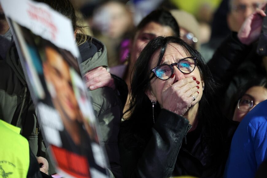 A woman reacts at 'Hostages Square' in Tel Aviv, where crowds gathered after militants in Gaza handed over the bodies of Israeli captives