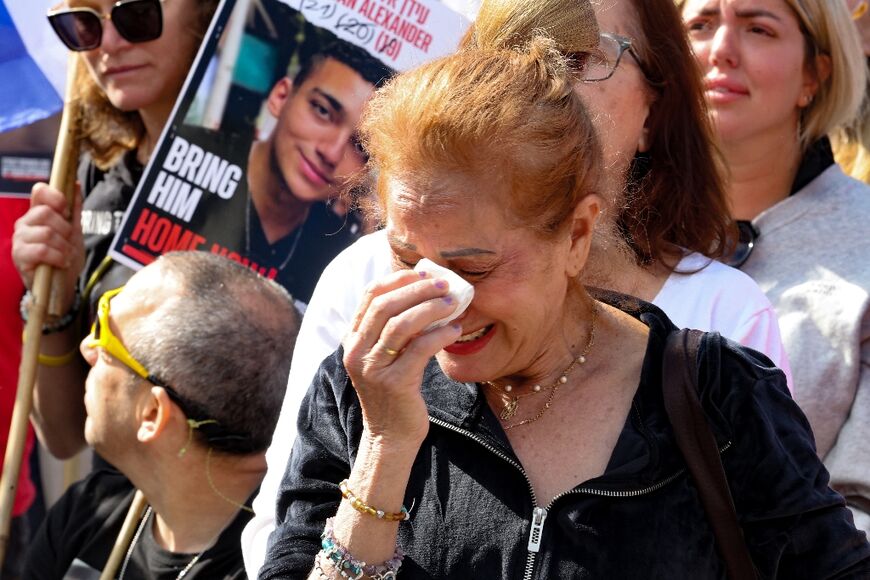 An onlooker reacts to the events on screen in Tel Aviv's 'Hostages Square'