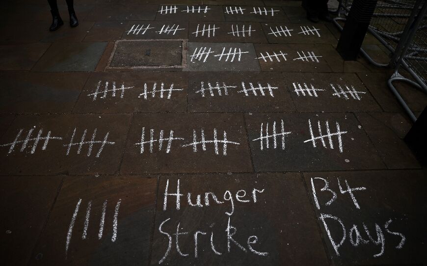 The count of Laila Soueif's hunger strike days chalked on the ground outside the gates of Downing Street