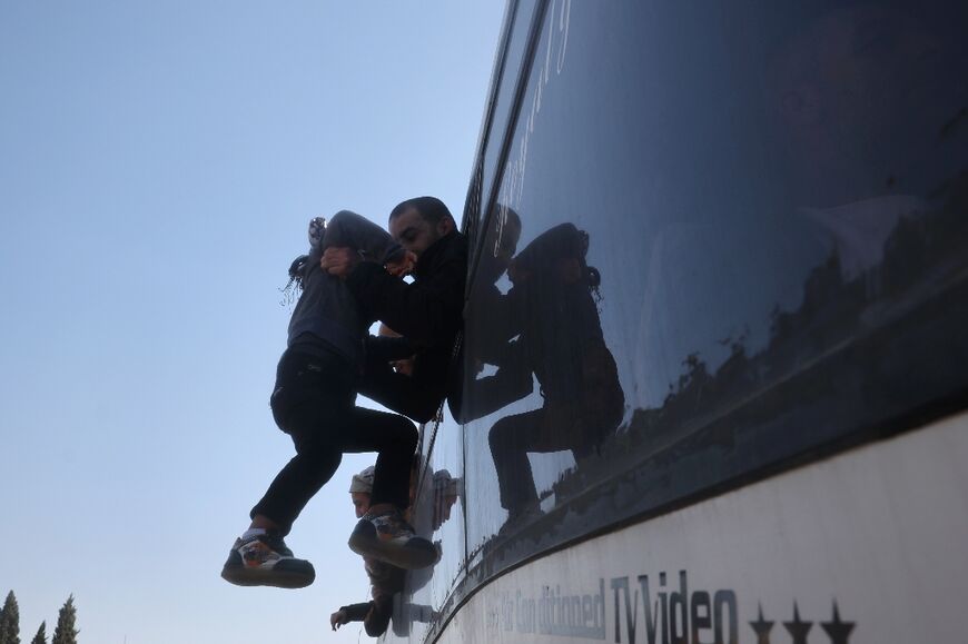 A former Palestinian prisoner, released as part of the sixth hostage-prisoner exchange, hugs a child upon arrival at the European Hospital in Khan Yunis, southern Gaza