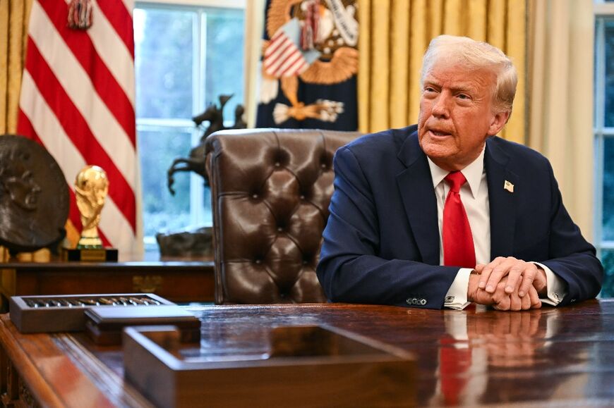 US President Donald Trump speaks to reporters in the Oval Office of the White House