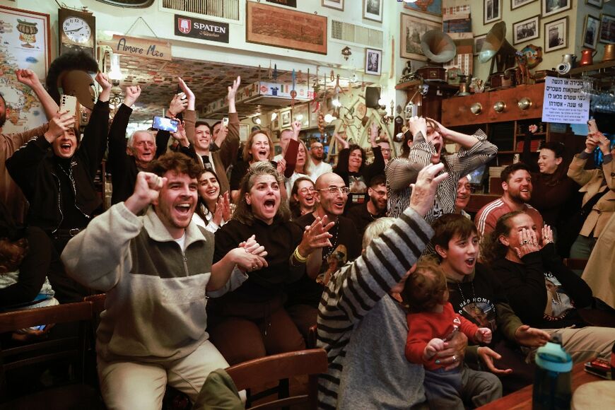 Family and friends of Israeli hostage Ohad Ben Ami cheer as they watch his release