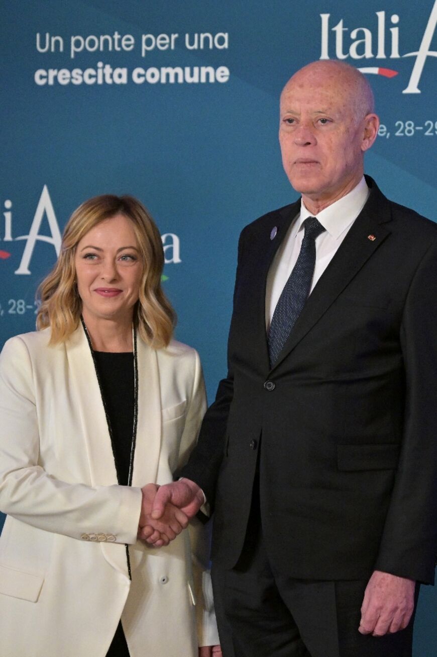 Italy's Prime Minister Giorgia Meloni greets Tunisia's President Kais Saied