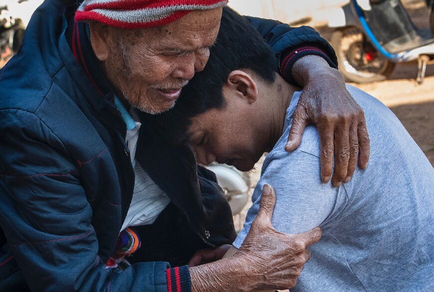 Freed Thai farm worker Watchara Sriaoun, held hostage in Gaza for more than a year, is greeted by his grandfather Sompong Sriaoun on his return to his hometown in Thailand's northeastern Udon Thani province