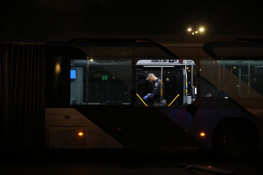 Security forces and bomb disposal units are deployed to the scene of a bus explosion in Bat Yam