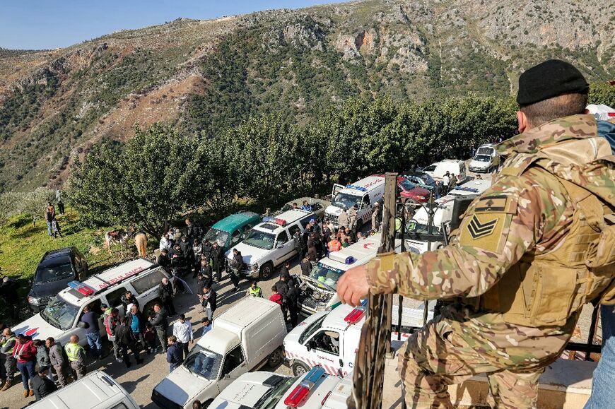 A Lebanese soldier stands guard as displaced residents return to Kfar Kila