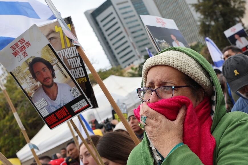 A woman at Tel Aviv's 'Hostages Square' reacts as she watches the release of hostages in Gaza