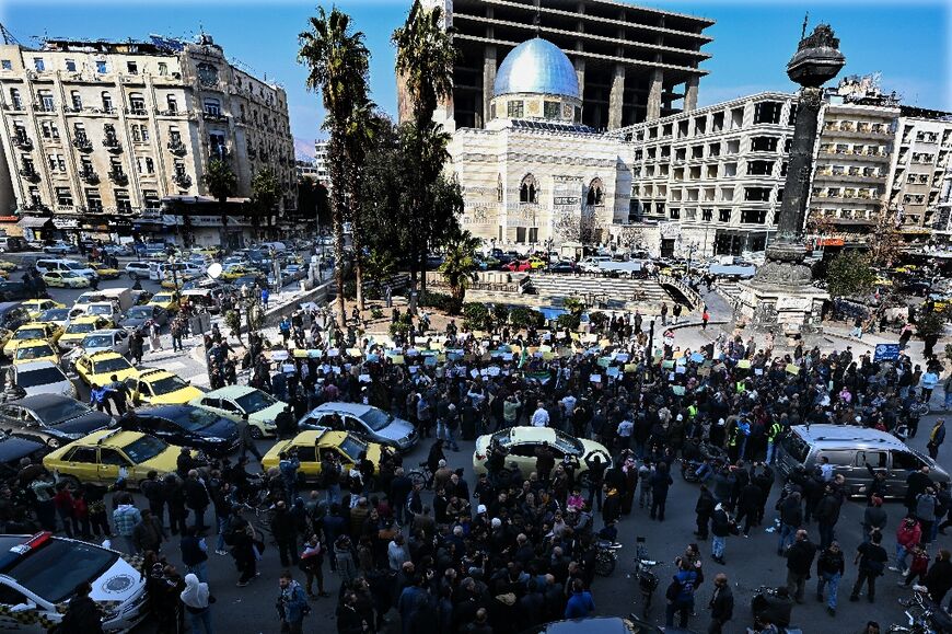 People gather at al-Marjeh square in Damascus for a rally called by Syrian activists "to mourn for the civilian and security personnel casualties" killed on Syria's coast