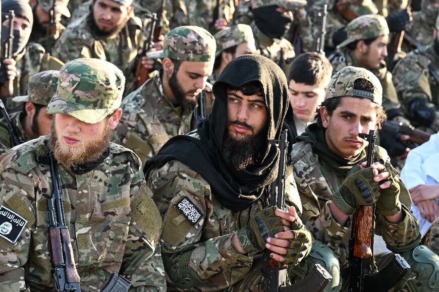 Members of the Syrian security forces join other Muslims for a special morning prayer for Eid al-Fitr, at the Tomb of the Unknown Soldier on Mount Qasyun, a site off-limits to most Syrians under former president Bashar al-Assad