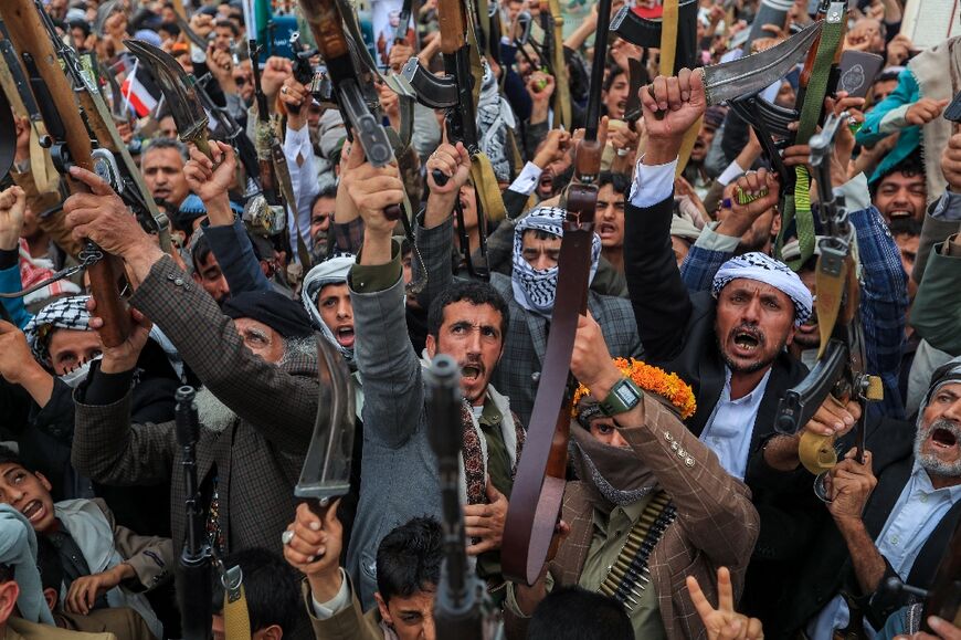 Armed Yemenis chant slogans during a rally in Sanaa in solidarity with Palestinians in Gaza