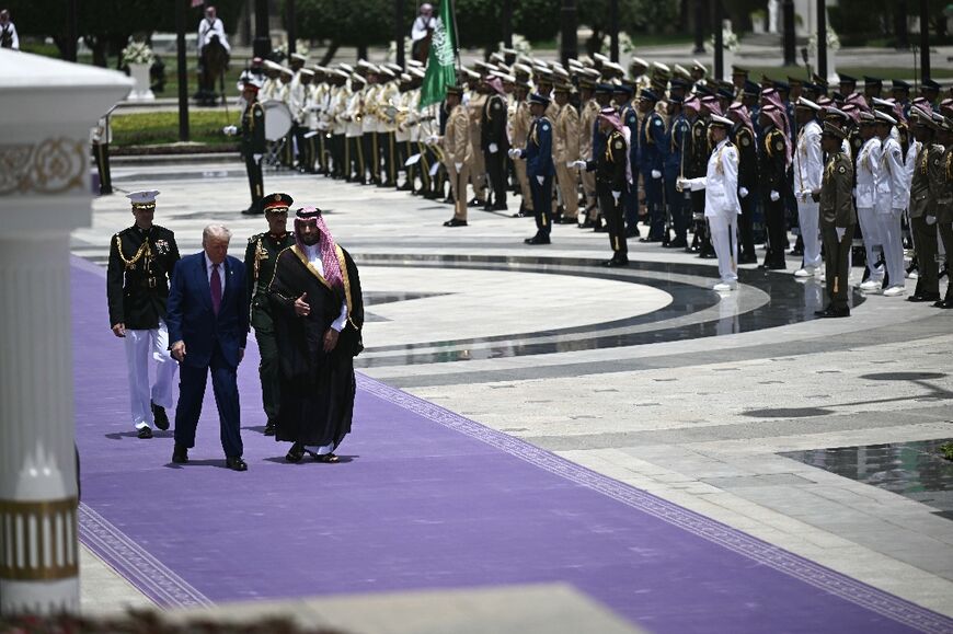 Saudi Crown Prince Mohammed Bin Salman and US President Donald Trump review the honour guard at the Royal Court in Riyadh 