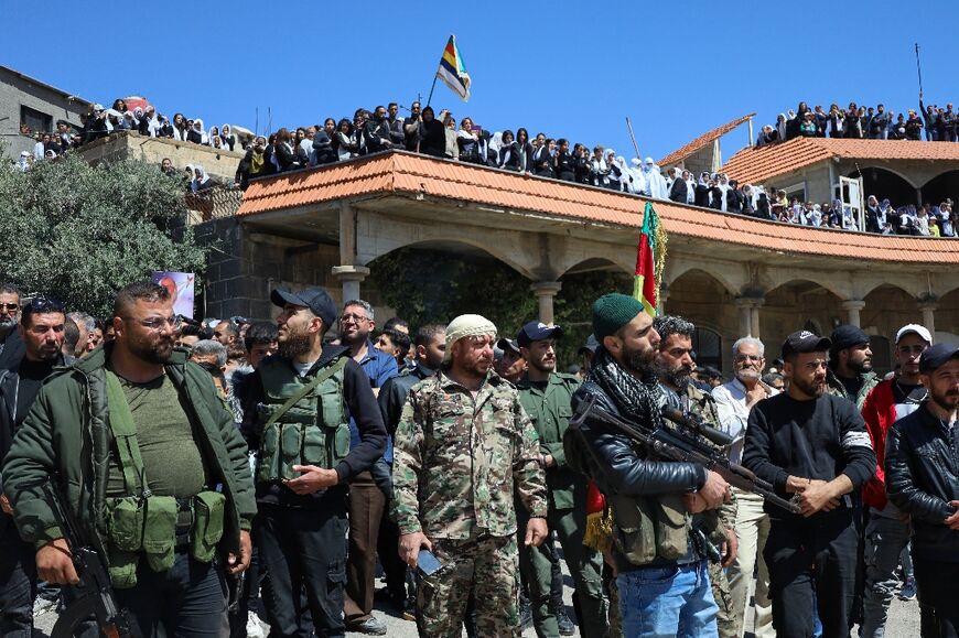 Armed Syrian Druze in the community's Sweida province heartland attend the funeral of comrades killed in sectarian clashes with loyalists of the Islamist-led government.