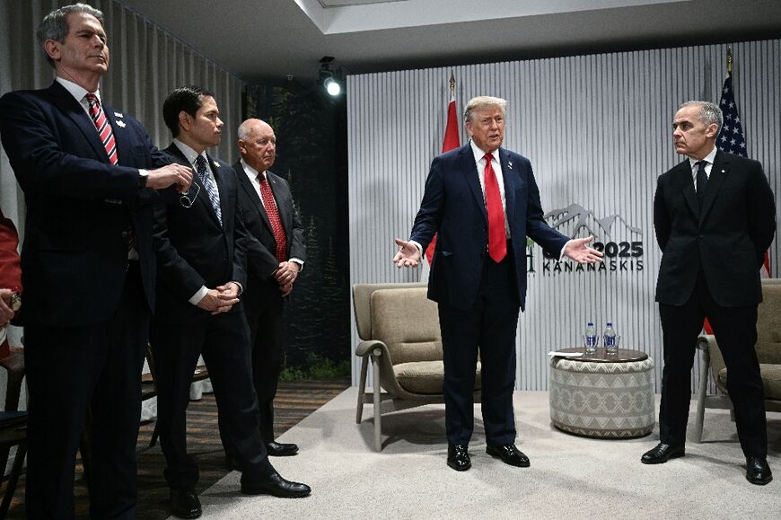 US President Donald Trump speaks as Canadian Prime Minister Mark Carney looks on as they meet during the Group of Seven summit in Kananaskis, Alberta, Canada 