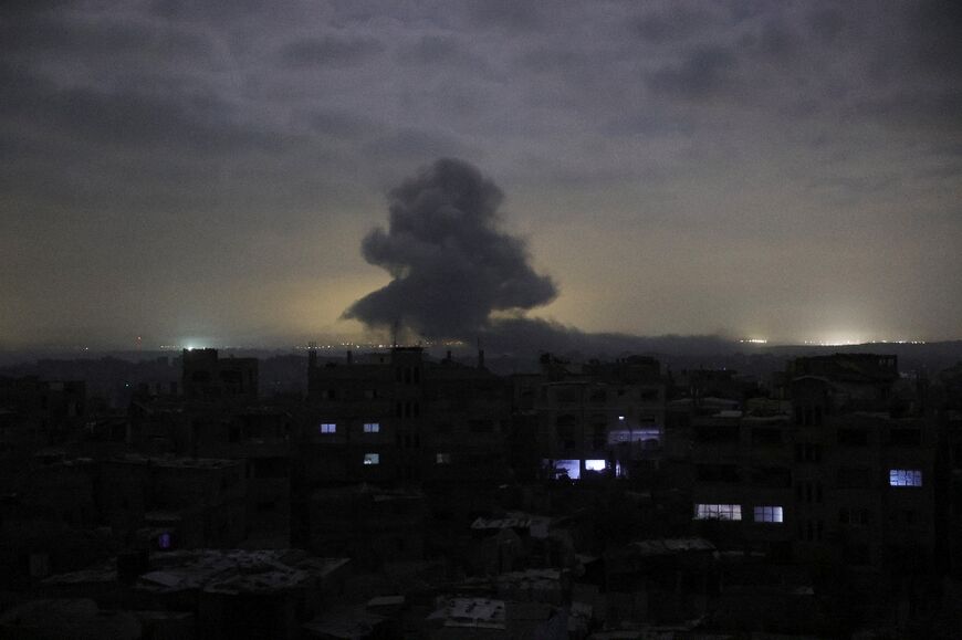 Smoke billows amid reported building detonations by Israeli forces to the east and north of Jabalia city in the northern Gaza Strip at dawn