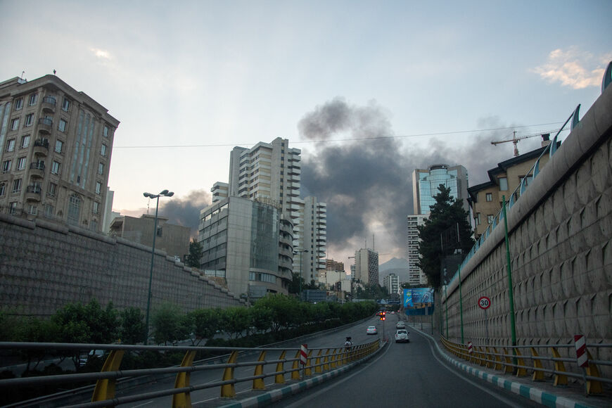 Smoke rises from the rubble of an Iranian state media building in Tehran after an Israeli airstrike on June 16, 2025. The strike, which Israel confirmed targeted "terror-linked propaganda infrastructure," marks a further escalation in regional tensions. (Photo by Nikan / Middle East Images via AFP) (Photo by NIKAN/Middle East Images/AFP via Getty Images)