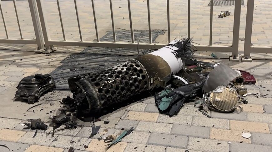 This frame grab take from AFPTV footage shows the remnants of an Iranian missile intercepted over Qatar, as it lies on a pavement near a fence on June 23, 2025.