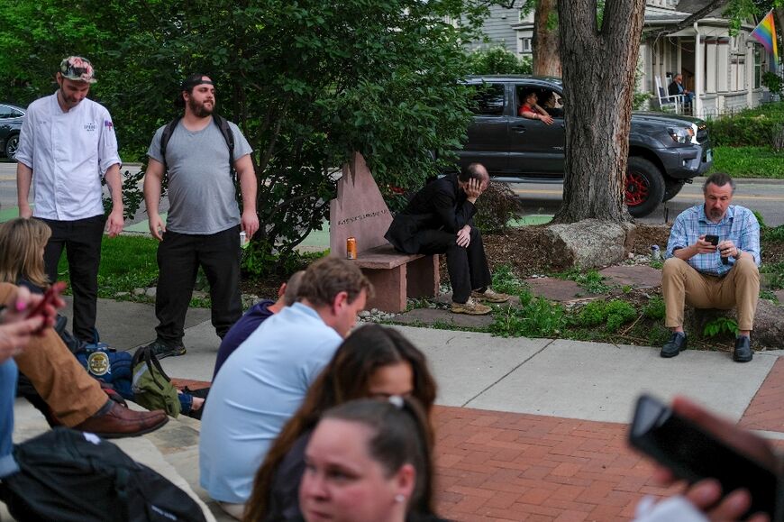 Hotel guests and employees who were evacuated wait outside after an attack on demonstrators calling for the release of Israeli hostages held in Gaza, on Pearl Street in Boulder, Colorado