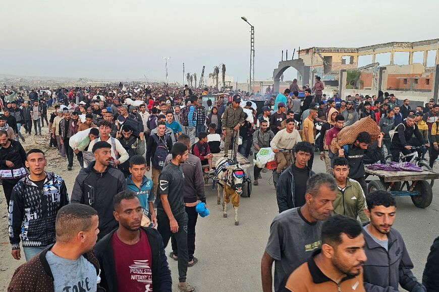 Displaced Palestinians return from a food distribution centre in Rafah in the southern Gaza Strip on June 1, 2025