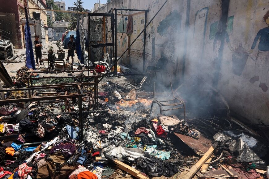 Piles of debris smouldered in the Gaza City school compound hit on Thursday