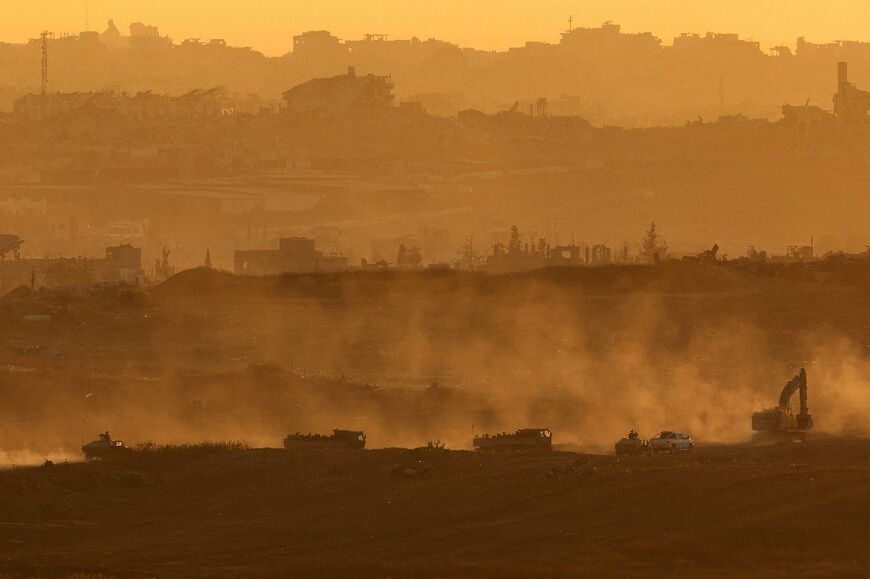 This picture taken from a position at Israel's border with the Gaza Strip shows Israelis army vehicles driving in the besieged Palestinian territory on July 8, 2025.