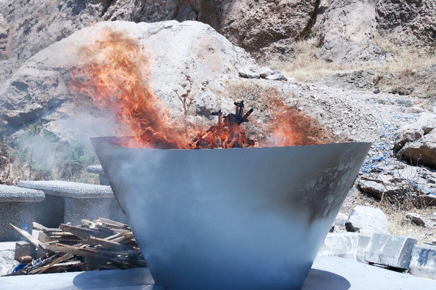 A first group of PKK militants burnt their weapons at a symbolic ceremony in northern Iraq  A first group of PKK militants burnt their weapons at a symbolic ceremony in northern Iraq