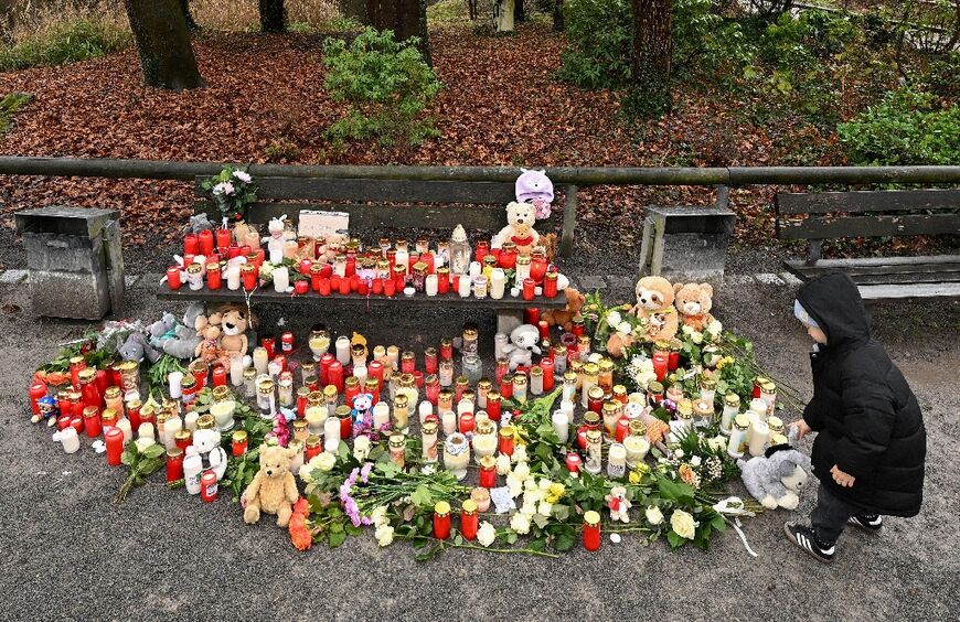 A child at a makeshift memorial for victims of the knife attack in Aschaffenburg, Germany, blamed on an Afghan migrant
