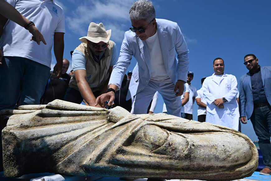 TOPSHOT - Egypt's Minister of Tourism and Antiquities Sherif Fathi inspects a recovered artifact at Abu Qir bay in Alexandria on August 21, 2025, as part of an event organized by the Ministry of Tourism and Antiquities to recover sunken antiquities. (Photo by Khaled DESOUKI / AFP) (Photo by KHALED DESOUKI/AFP via Getty Images)