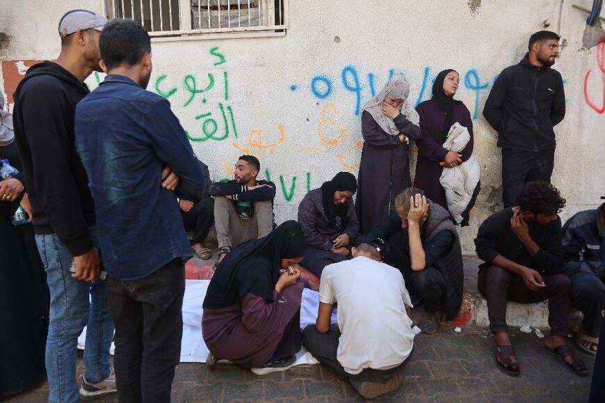 Palestinians mourn over the body of a relative who was killed in overnight Israeli strikes on Gaza