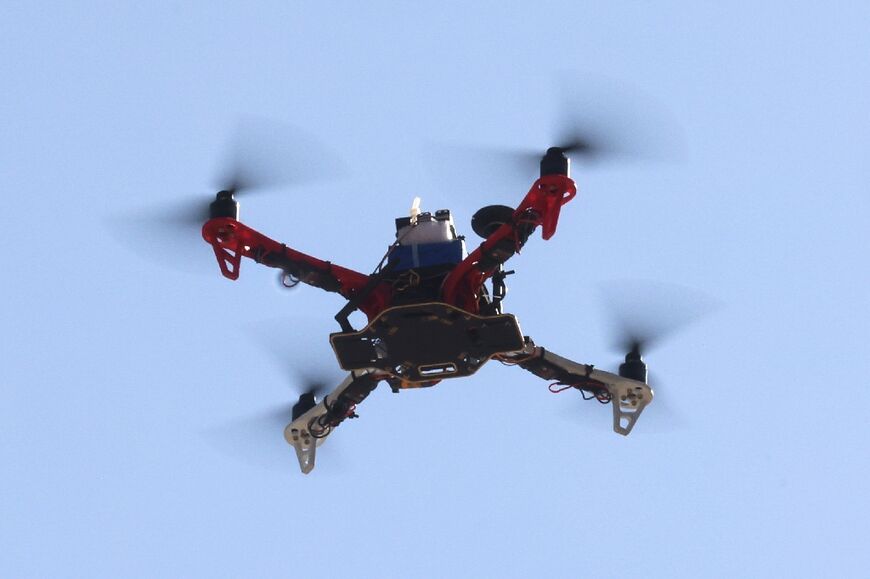 A drone built by engineering students executes a test flight at Iran's Tech Olympics