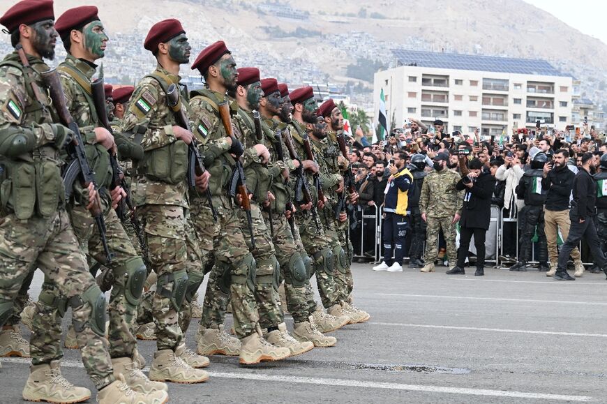 Jubilant crowds lined the streets to watch a military parade in Damascus