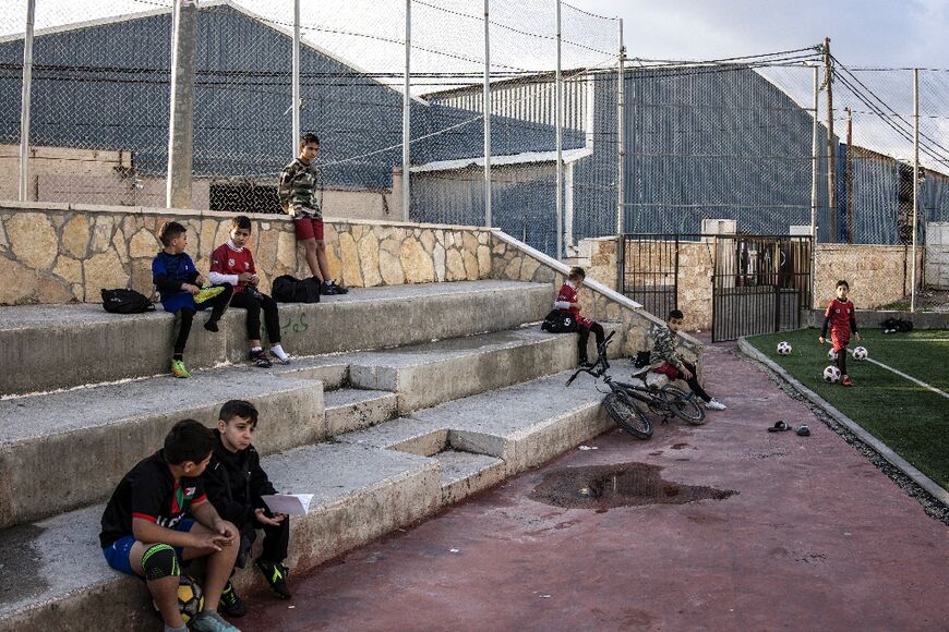 Boys from Aida Refugee Camp near Bethlehem take a break before their football training
