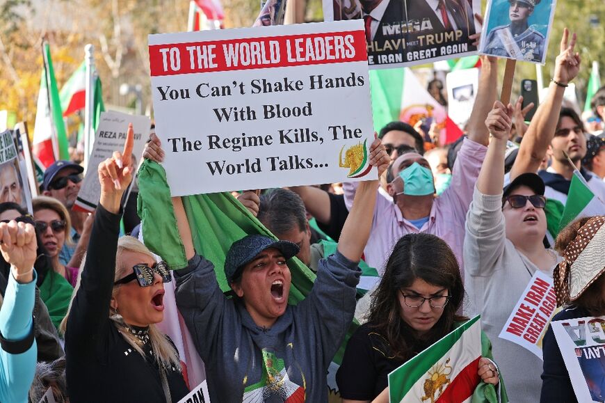 US protesters could be seen carrying signs &nbsp;condemning a "New Holocaust," a "genocide in the making," and the "terror" of the Iranian government