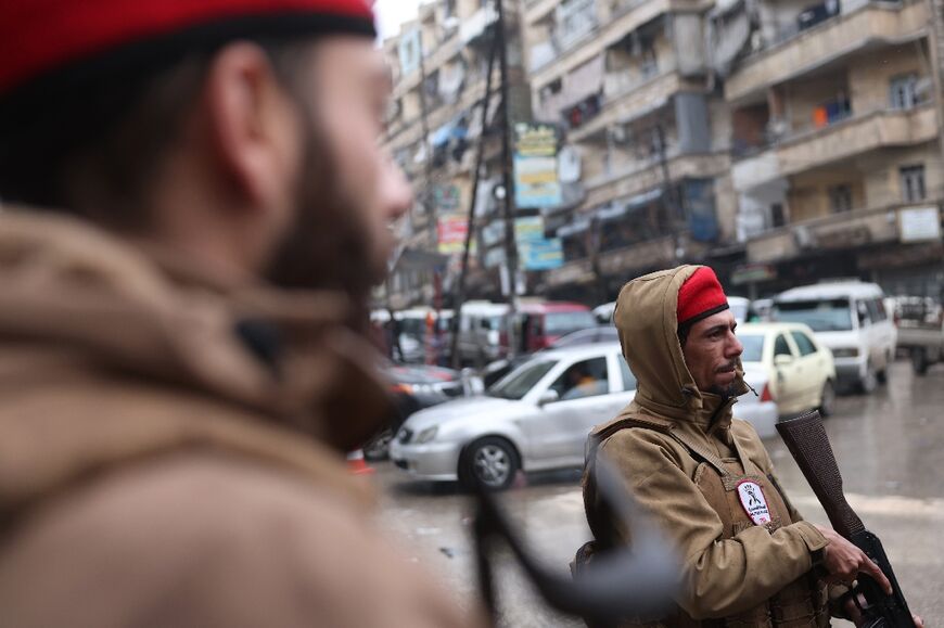 Syrian security officers patrol the streets following a ceasefire in a Kurdish-majority neighbourhood of Aleppo