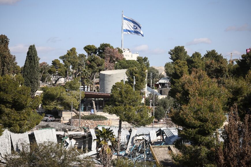 An Israeli flag fluttered above the demolished structures inside the UNRWA headquarters 