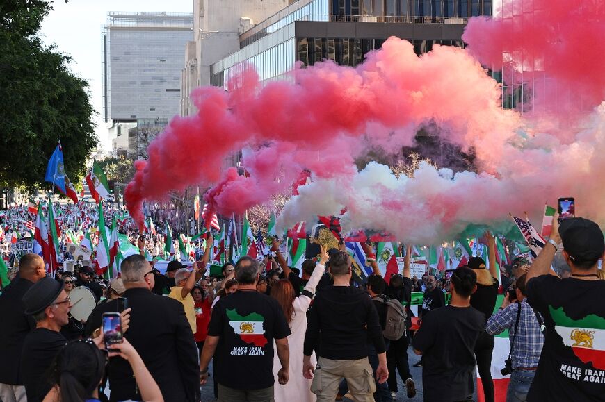 Protesters held up canisters releasing smoke in the colors of the Iranian flag during the Los Angeles rally