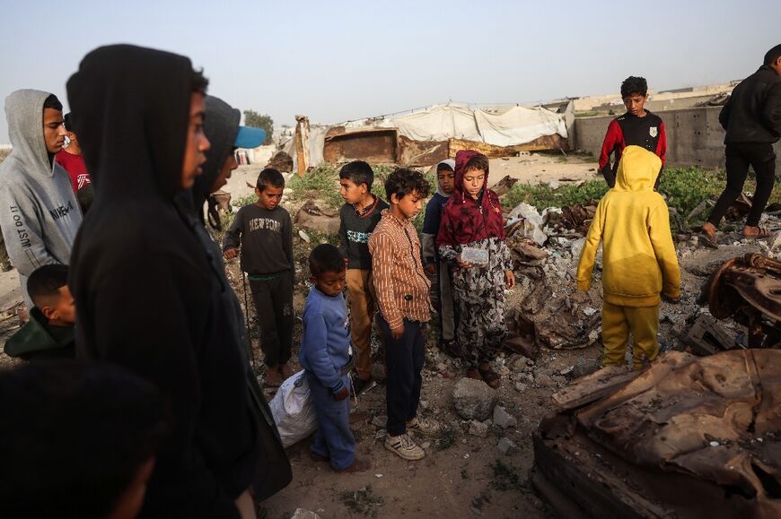 Palestinian youths at the scene of an overnight Israeli strike