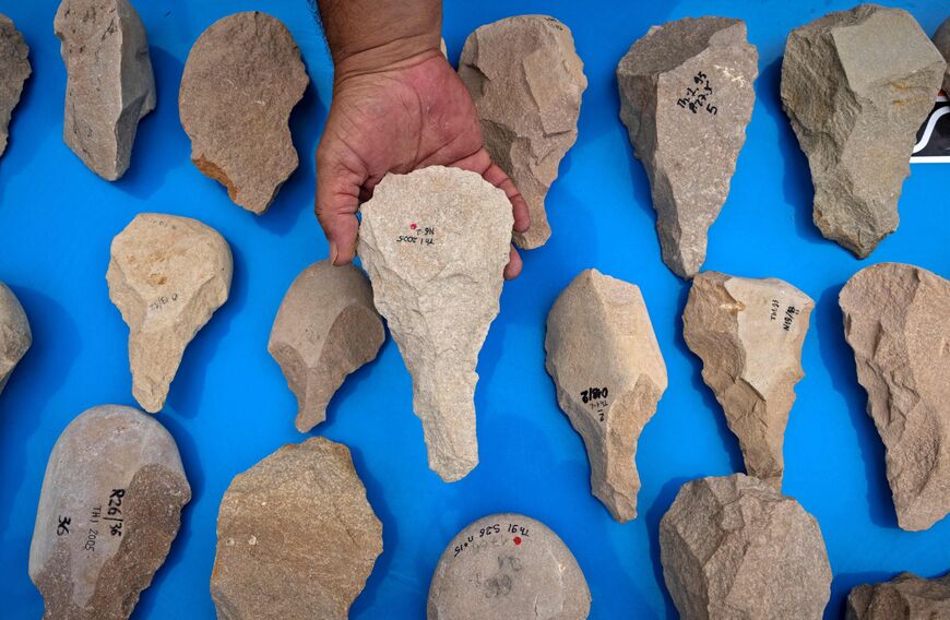 The guardian of the archaeological site "Thomas Quarry I" shows Acheulean stone tools in the Moroccan city of Casablanca, on July 29, 2021. - Archaeologists in Morocco have announced the discovery of North Africa's oldest Stone Age hand-axe manufacturing site, dating back 1.3 million years, an international team reported on July 28. The find pushes back by hundreds of thousands of years the start date in North Africa of the Acheulian -- referring to the period of the main Lower Palaeolithic culture in Europ