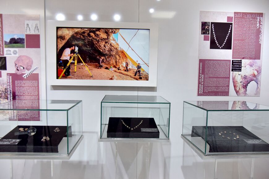 A picture taken on November 18, 2021 in Rabat shows artefacts unvailed by archaeologists in Morocco which they say are one of the oldest in the world. - Archaeologists in Morocco unveiled what they said was the oldest jewelry in the world, perforated seashells dating back as much as 150,000 years. The shells, assumed to have formed necklaces and bracelets, were discovered in the Bizmoune cave near the coastal resort of Essaouira. They were dated as 142,000-150,000 years old, according to researcher Abdeljal