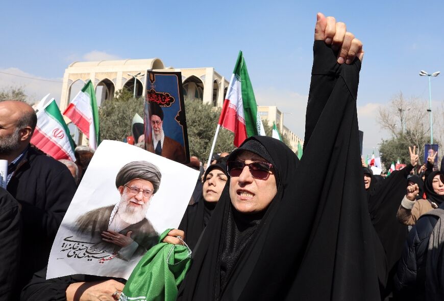 People hold portraits of Iran's slain supreme leader Ayatollah Ali Khamenei as they take part during an anti US-Israel demonstration after Friday prayer in Tehran on March 6
