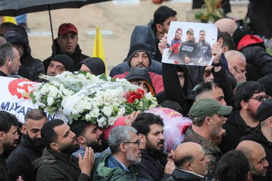 Mourners carry the body of one of the three journalists killed