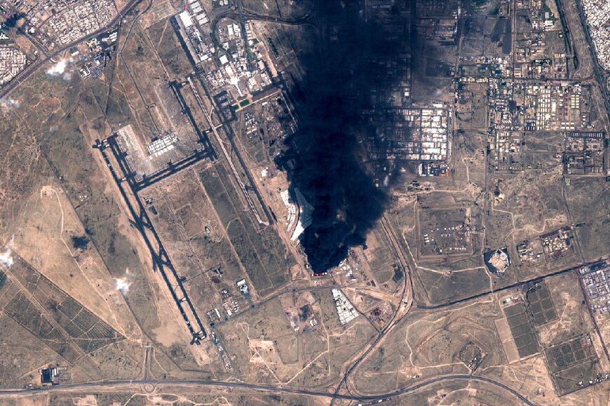 A satellite image showing smoke plumes billowing in the vicinity of Kuwait International Airport after it was hit by drones