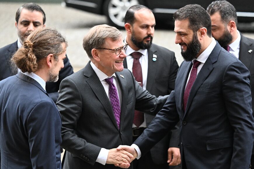 Syrian President Ahmed al-Sharaa is welcomed by German Foreign Minister Johann Wadephul ahead a German-Syrian roundtable meeting on the economy 