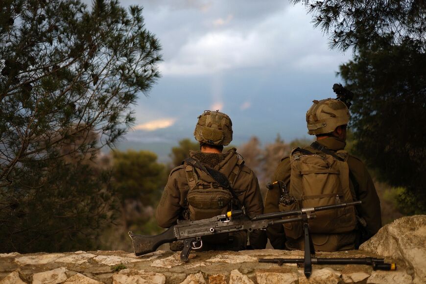 Israeli soldiers take a position along the Israel-Lebanon border 
