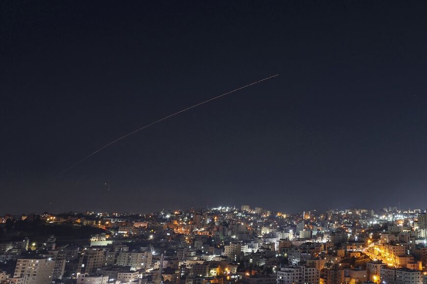 Rocket trails are seen in the sky above the city of Hebron, in the Israeli-occupied West Bank, amid a fresh barrage of Iranian missile attacks on March 4