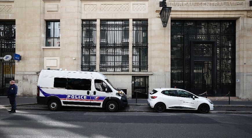 Police and private security vehicles outside the Bank of America building in Paris's chic 8th arrondissement