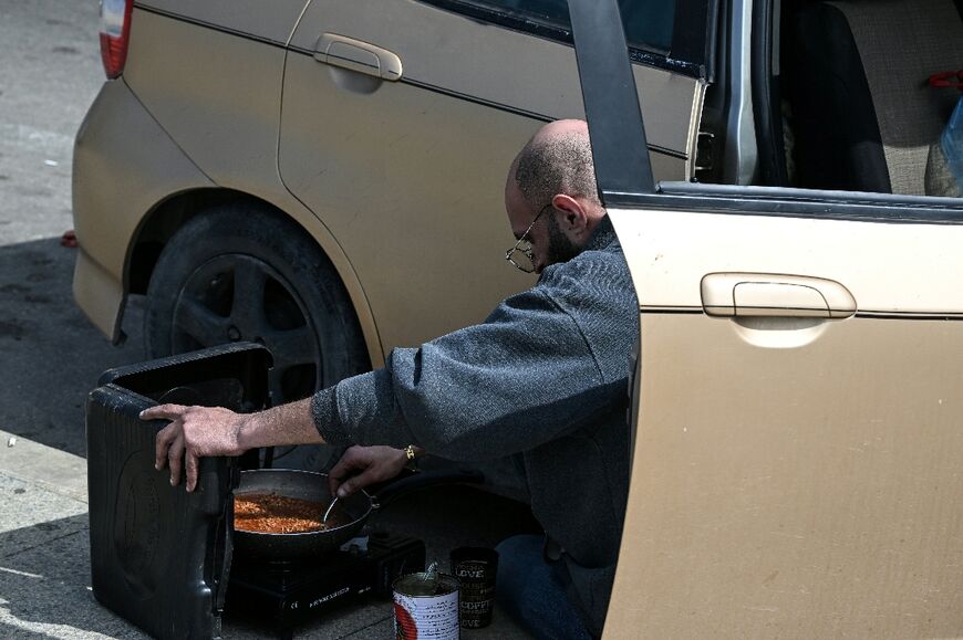 Some of those displaced have been forced to get by in the streets, cooking next to their cars