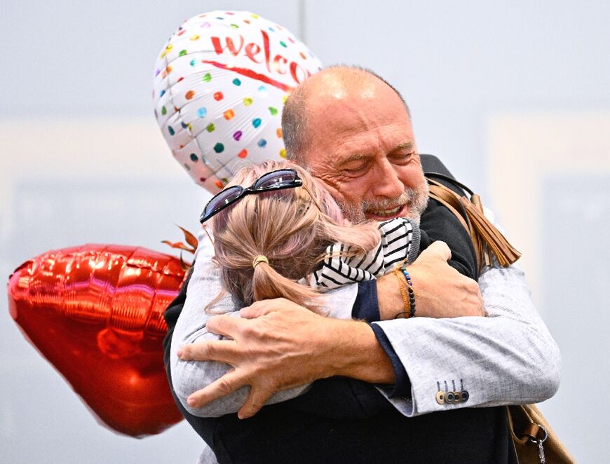 Air travelers, who were stranded in Dubai, are greeted upon arrival at the airport in Schwechat near Vienna, on March 5, 2026