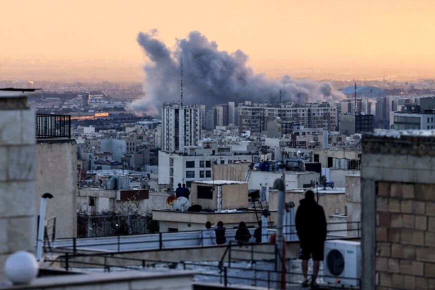 A plume of smoke rises after a strike on the Iranian capital Tehran