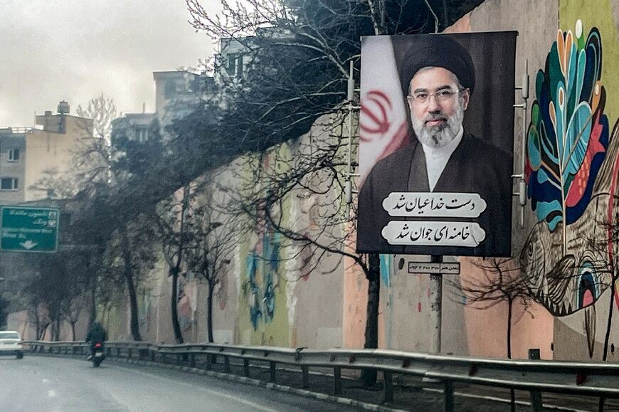 A banner depicting Iran's new Supreme Leader Ayatollah Mojtaba Khamenei on the side of a highway in Tehran on March 10, 2026
