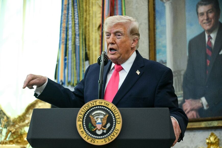 US President Donald Trump, seen here in the Oval Office on March 24, said negotiations with Iran to end the Middle East war were underway "right now"